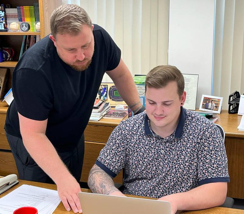 St. Mark's Lutheran Church Rev. Jamie Holt (left) and Director of Education Alex Brice review the travel plans for the upcoming national youth conference. Twenty-one youth from the St. Charles church will be attending the conference.