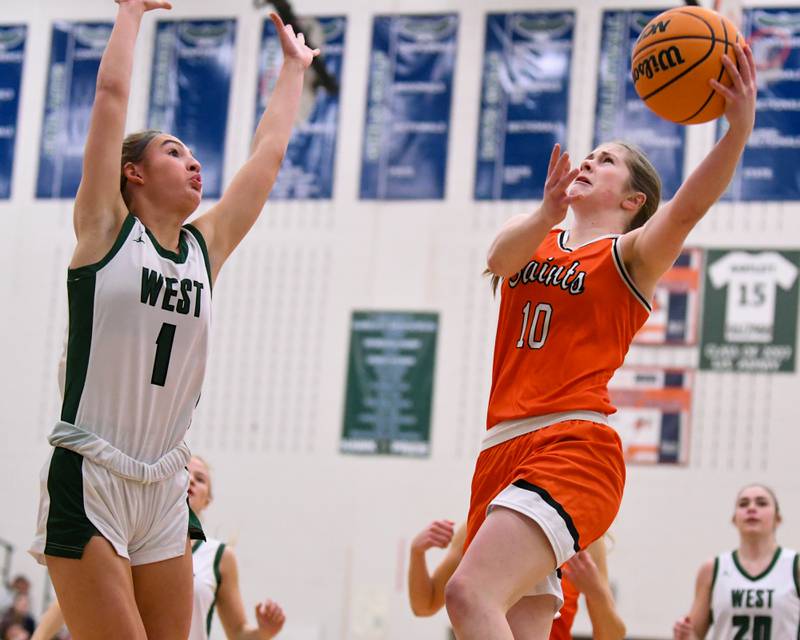 St. Charles East's Kathlyn Bainbridge (10) makes a basket while being defended by Glenbard West's Nina Hendricksen (1) during the 4A Sectional championship game on Thursday Feb. 26, 2026, held at Bartlett High School.