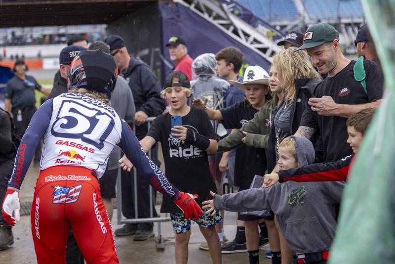 Despite the heavy rain Excited young fans reach out to try and receive a high five from motorcross superstar Justin "Bam Bam" Barcia at the Super Motocross Finals on September 16, 2023.