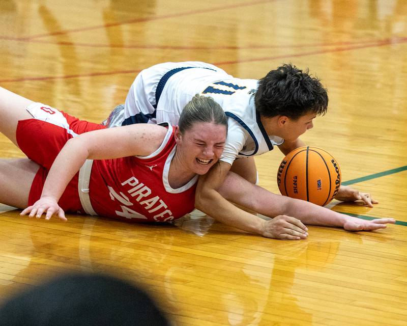 Joslynn James (11) of Sterling and Ottawa's Kennedy Kane (24) battles over loose ball on floor during Regional Championship game on Thursday, Feb. 19, 2026 in Sellett Gymnasium at L-P High School.