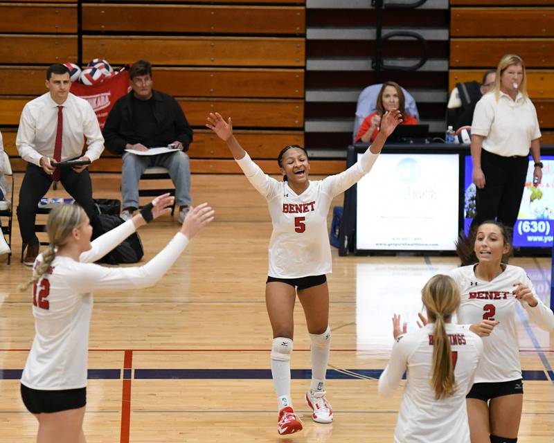 Benet Academy's Brooklynne Brass (5) celebrates with the team after scoring a point during the sectional championship game while taking on St. Charles North on Thursday Nov. 7, 2024,  held at West Aurora during the 4A sectional championship game.