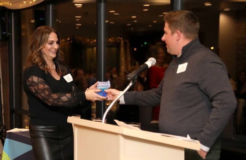 Candice Ellensohn accepts the 2023 Geneva Chamber of Commerce Ambassador of the Year Award from Chris Wallace during the chamber’s annual dinner and awards at Riverside Receptions in Geneva on Thursday, Nov. 2, 2023.