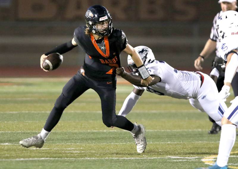 DeKalb's Cole Latimer tries to break away from Plainfield South's Jeremiah Ranceful during their game Friday, Sept. 1, 2023, at DeKalb High School.