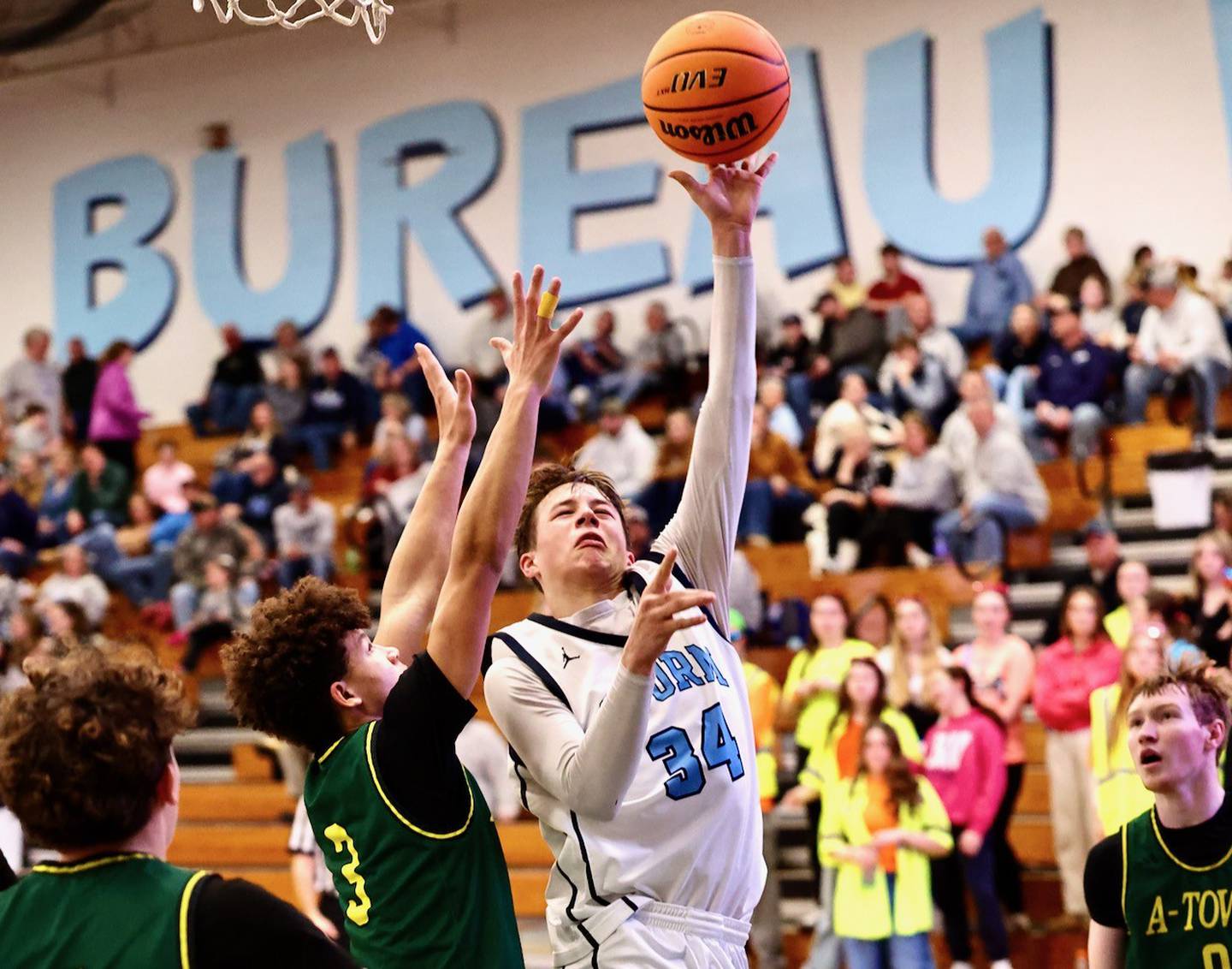 Bureau Valley's Carson Gruber shoots against Abingdon-Avon's Tre Kenon for the game-tying basket Friday night at the Storm Cellar. A-Town won 47-45.