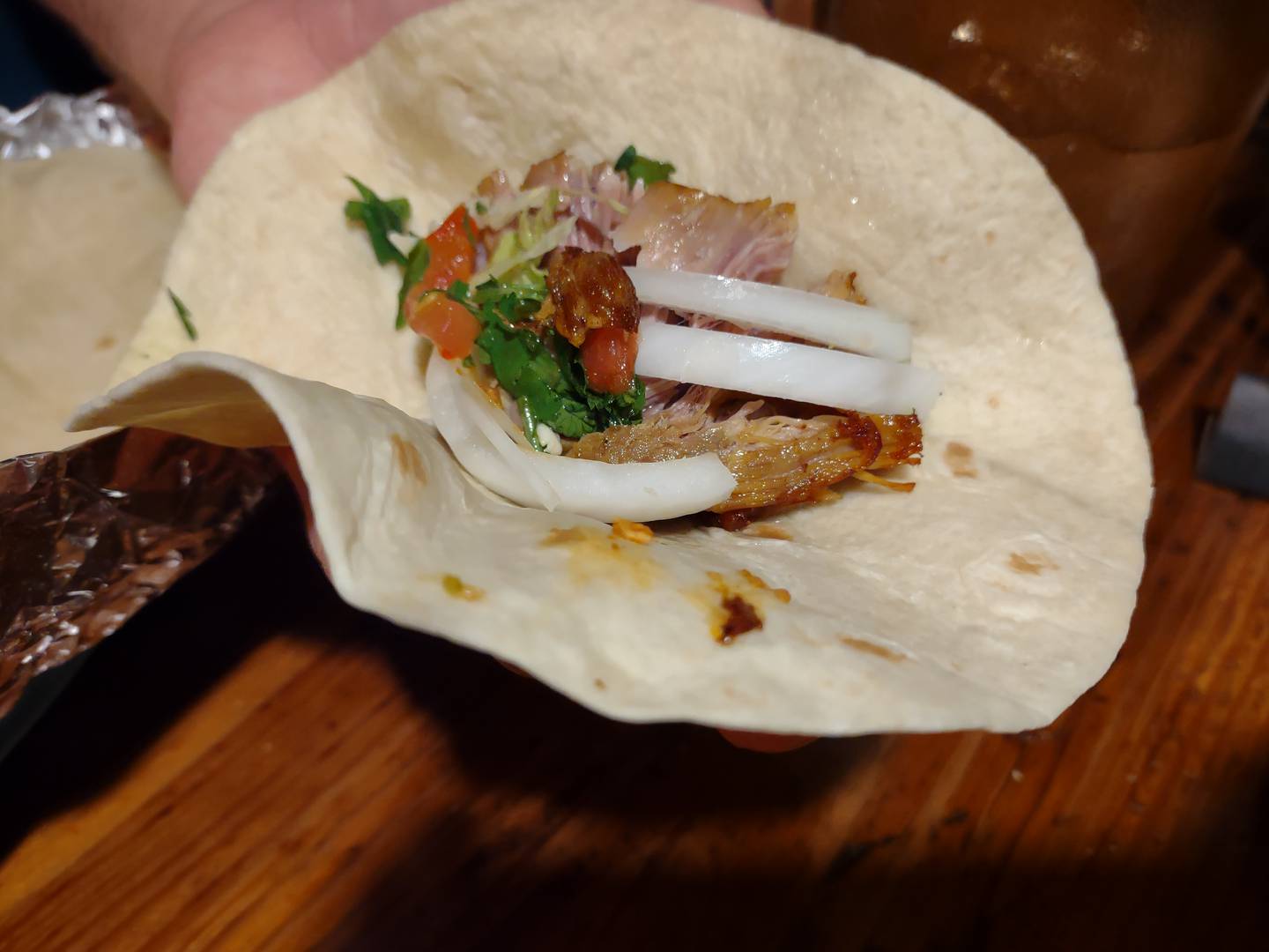 Three flour tortillas are provided with the carnitas meal to make wraps of meat, onion and pico de gallo at La Fondita Mexican Grill in Ottawa.