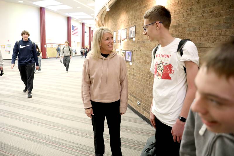 Leann Philgren, a special education teacher and track and field coach at Westmont High School, talks to students Joey McCullough and Ben Munsie.