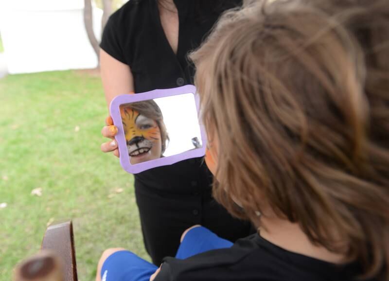 Children including Jackson Plasman of Lombard get their face painted during the Elmhurst Art Festival Saturday April 30, 2022.