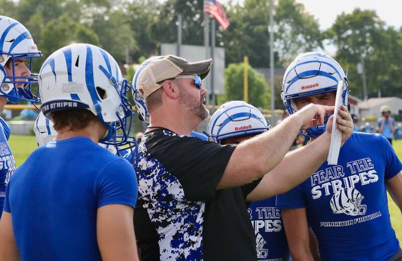 PHS coach Ryan Pearson goes over plays with the Tigers during Monday's 7 on 7 games with Bureau Valley and Annawan-Wethersfield at Little Siberia.