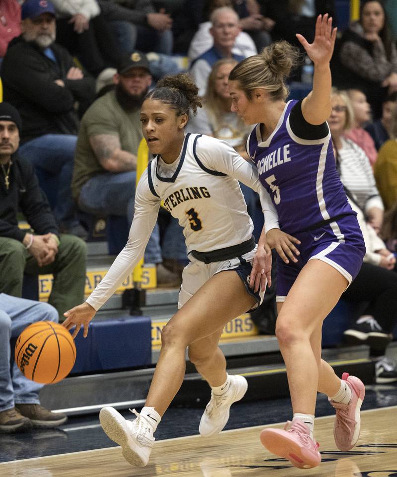 Sterling’s Delali Amankwa works against Rochelle’s Payton Ceserone Monday, Feb. 17, 2025, during the girls 3A regional semifinal game in Sterling.
