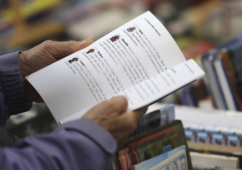 Susan Allman of Barrington looks at a book during the Environmental Defenders of McHenry County's annual Big Fall Book Sale on Tuesday, Sept. 26, 2023, at the Algonquin Township Road District Building B Garage. The sale continues on Monday, Oct. 2, from 10am-4pm through Saturday, Oct. 7.