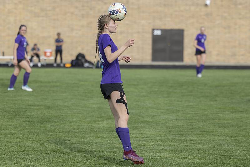 Dixon’s Maggie Van Sickle heads the ball against Sterling Tuesday, May 9, 2023.