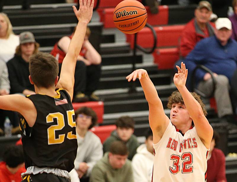 Hall's Payton Dye (32) shoots a jump shot over Putnam County's Wyatt Grimshaw (25) during the Colmone Classic on Tuesday, Dec. 6, 2022 at Hall Hight School in Spring Valley.