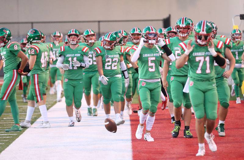 Members of the L-P football team walk off the field after Metamora scores the first touchdown of the game on Friday, Sept. 1, 2023 at Howard Fellows Stadium.