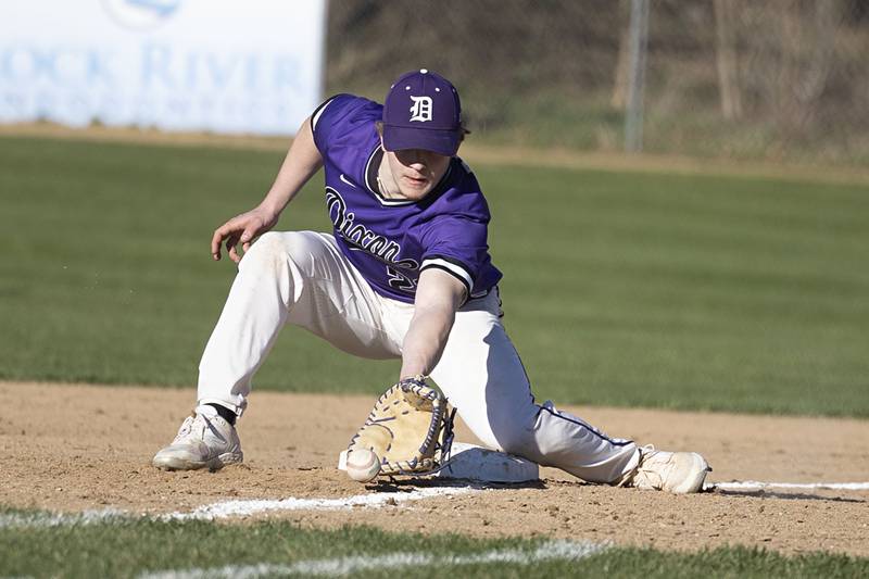 Dixon’s Quentin Seggebruch scoops a ball at first for an out against Winnebago Thursday, April 6, 2023.