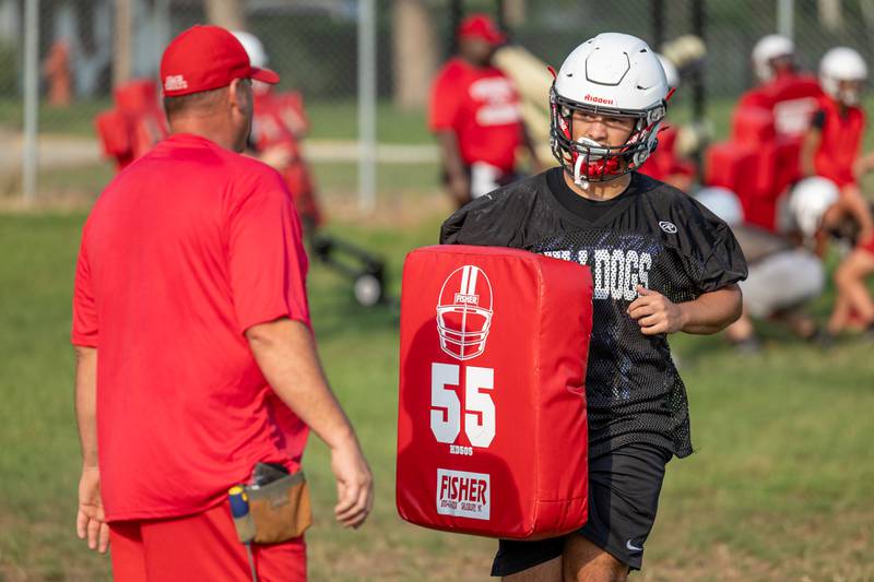 (left to right) Coach Jason Schultz talks to Jerrod Clark of Streator as he jogs back to drill on Monday, August 11, 2025 at Streator High School in Streator.