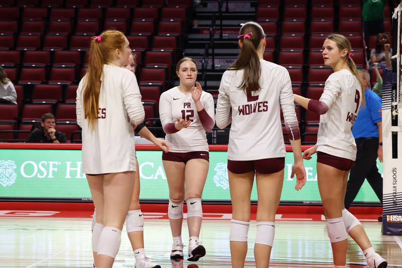 Prairie Ridge players gather in consolation following the Wolves' loss in two sets, 25-20, 25-18, in the IHSA Class 3A State semifinals on Friday, Nov. 14, 2025.