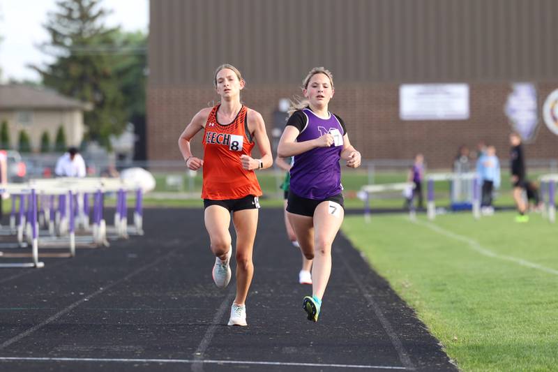 Manteno's DeLanie Monroe, right, strides out to take first place ahead of Beecher's Rachel Imig during the 3200-meter race at the Manteno Track Invite on Friday, April 24, 2026.
