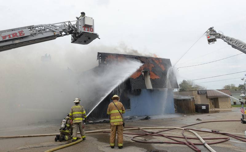 Firefighters from several departments responded to a structure fire at the corner of Main Street and Wesley Avenue in downtown Mt. Morris on Tuesday, April 16, 2024. The wooden structure housed two apartments and Sharky's Sports Bar. No injuries were reported. Firefighters battled high winds during the afternoon blaze.