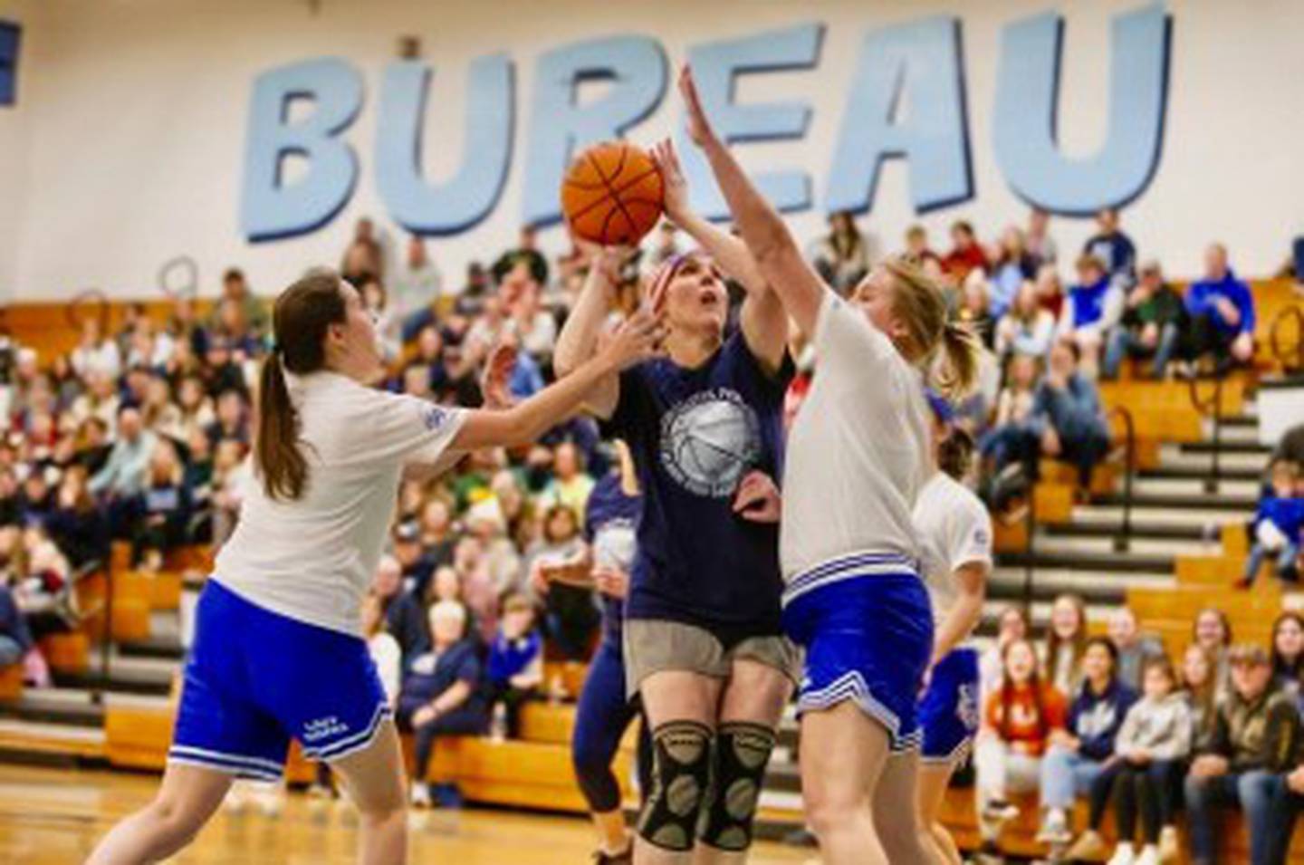Melissa (Milby) Jackson, who played on Bureau Valley's first team in 1995-96, shoots over PHS alums Kelly (VanDenBussche) Bostrom and Sara Grieff brings the ball upcourt during Sunday's Alumni Game at the Storm Cellar.