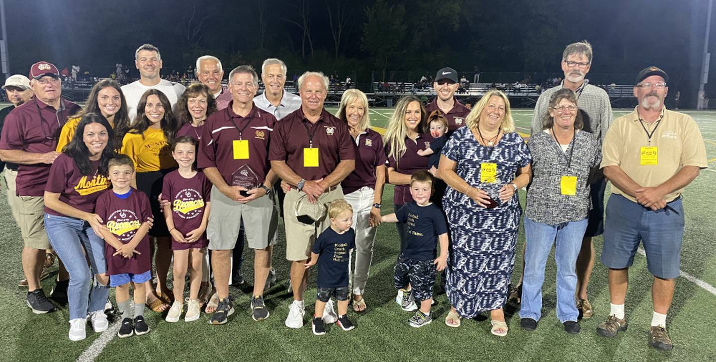 Pictured are the honorees and their families on the Montini Catholic football field at halftime.