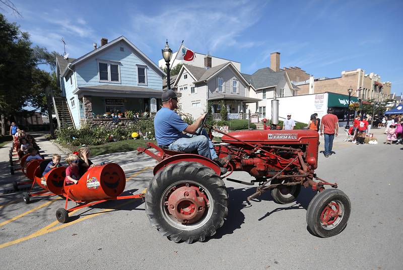 Devin Harms drives the Pumpkin Train during the Johnny Appleseed Festival on Saturday, Sept. 27, 2025, in downtown Crystal Lake. The festival featured live performances, food and family-friendly activities.