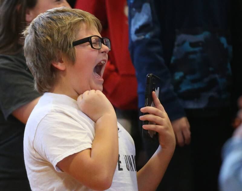 Austin McKinnon a student at Marseilles Elementary School sings with Tom Morello on Thursday, Nov. 30, 2023. Morello is best known for his tenure with the rock bands Rage Against the Machine and Audioslave. Morello grew up in Marseilles before making it to the major music industry.