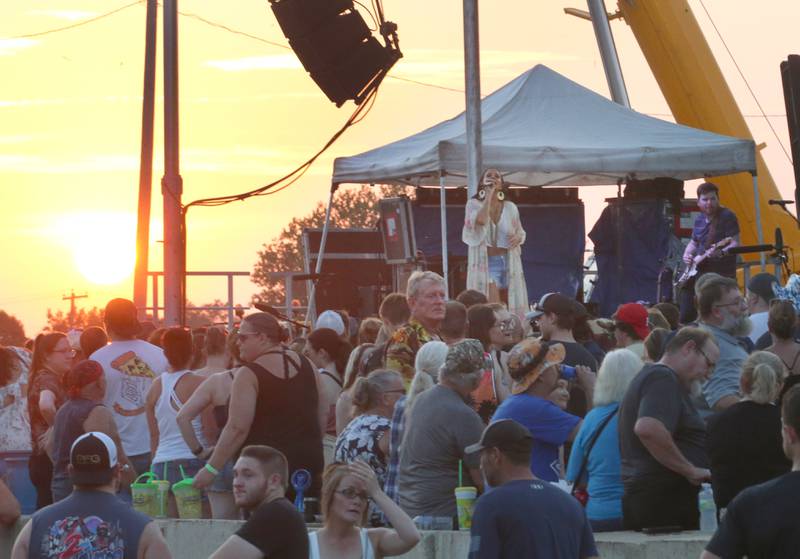 The sun sets behind Country Music star Sara Evans on Thursday, Aug. 24, 2023 at the Bureau County Fair in Princeton.