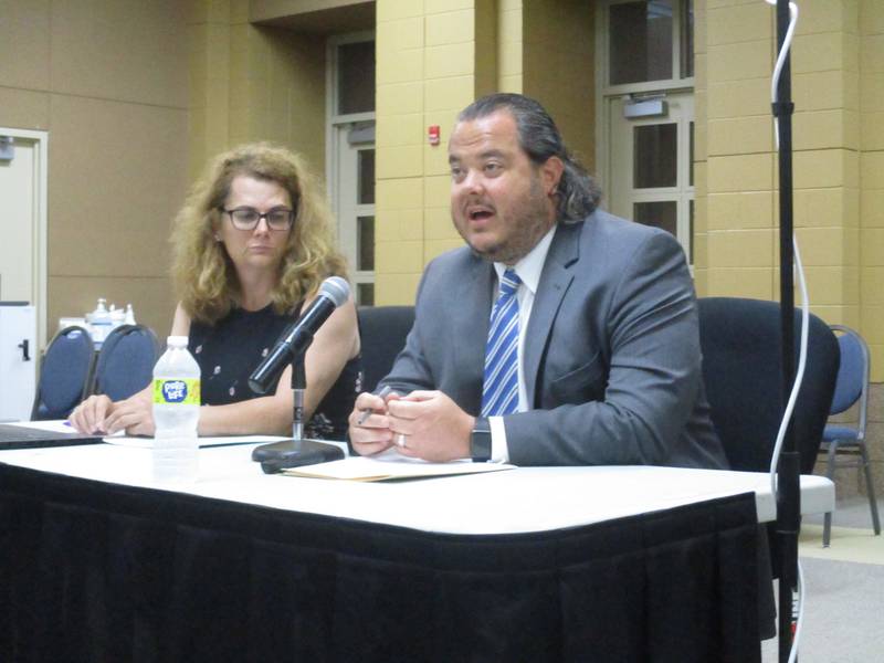 Oswego Village Administrator Dan Di Santo speaks to the Oswego School District 308 Board of Education on Aug. 9, 2022, as village Public Works Director Jennifer Hughes listens. (Mark Foster -- mfoster@shawmedia.com)