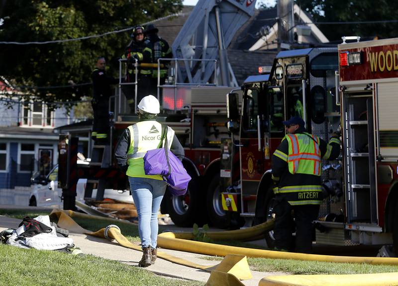 A Nicor Gas worker at the scene a house fire in the 300 block of Lincoln Avenue in Woodstock Monday, Oct. 9, 2023, after an explosion following suspected gas leak in the area.