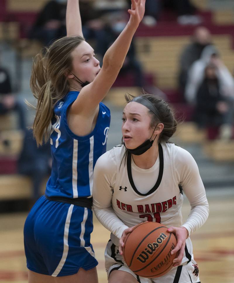 Huntley's Samantha Campanelli looks to shoot past Burlington Central defender Page Erickson during their game on Saturday, January 29, 2022 at Huntley High School. Huntley won 52-49.