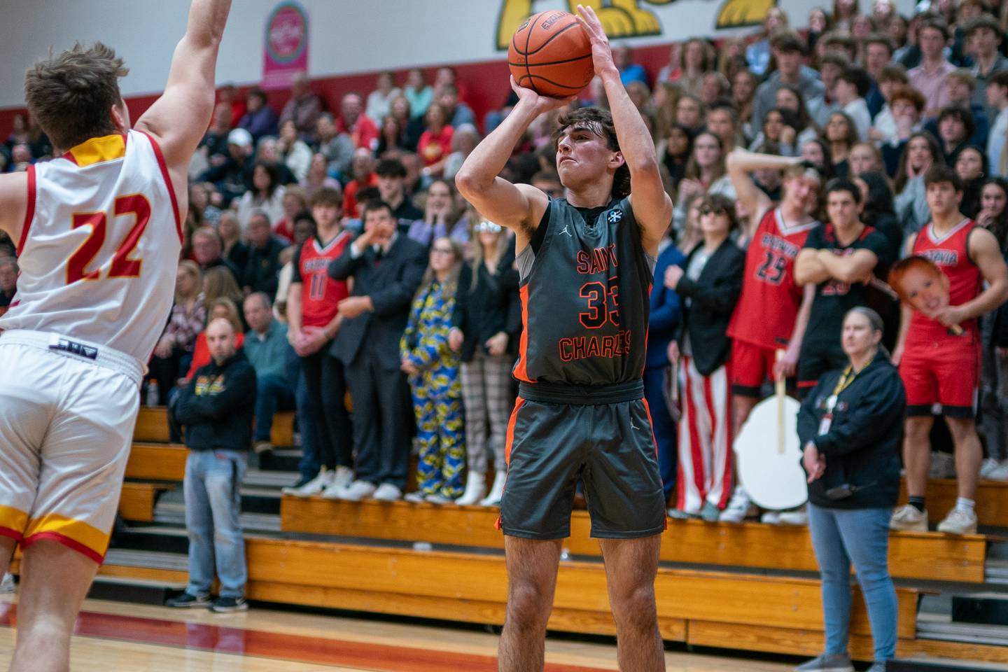 St. Charles East's Ben Hirata (33) shoots the ball against Batavia’s Charlie Whelpley (22) during a basketball game at Batavia High School on Friday, Feb 10, 2023.