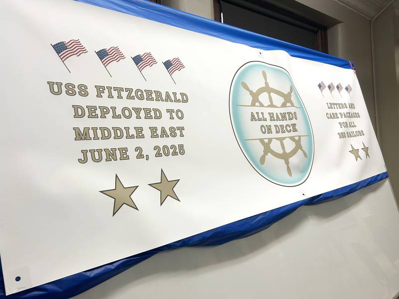 A large "All Hands on Deck" banner was on the wall of the basement at the Evangelical Free Church of Mt. Morris  on Thursday, Oct. 16, as volunteers assembled care packages for sailors on the USS Fitzgerald.