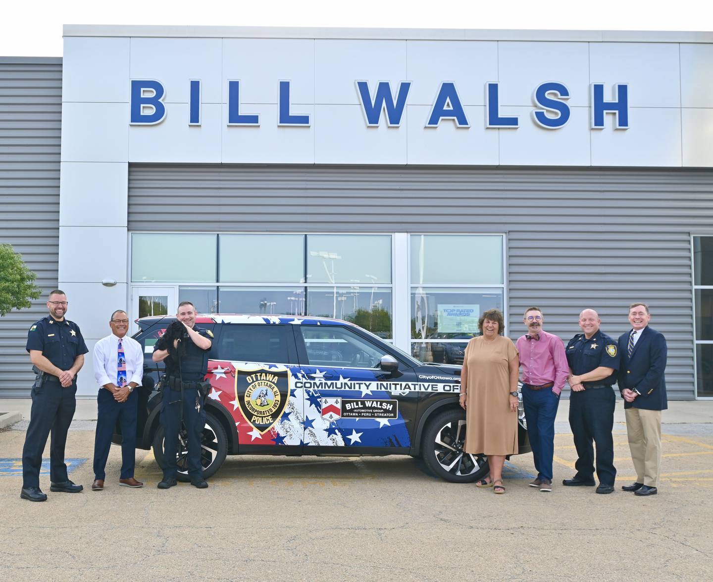 From left: Police Capt. Kyle Booras, La Salle County States Attorney Joe Navarro,  Community Initiative Officer Tyler Brewer holding K9 Rookie, United Way Executive Director Sally Honiotes, Ottawa Mayor Robert Hasty, Ottawa Police Chief Brent Roalson and Bill Walsh Jr.