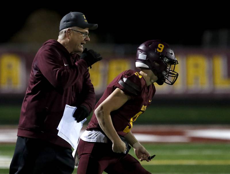 Richmond-Burton Head Coach Mike Noll yells a play to quarterback Ray Hannemann during an IHSA Class 4A first-round football game on Friday, Nov. 1, 2024, at Richmond-Burton High School in Richmond.