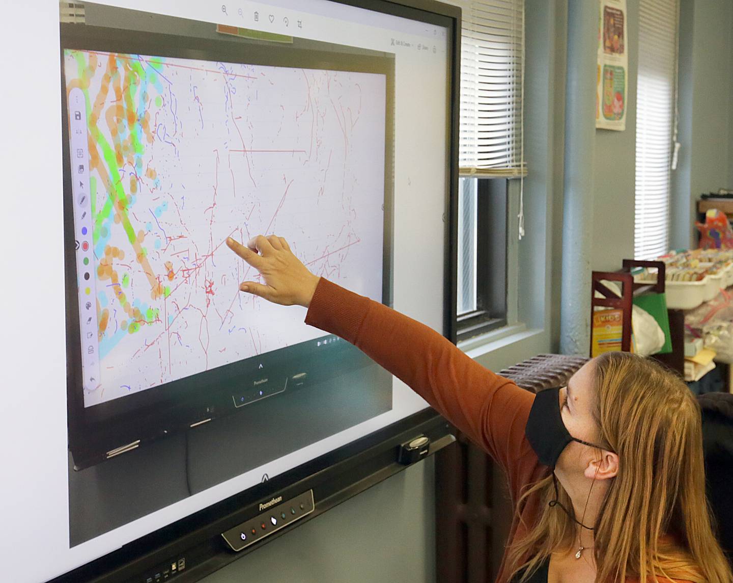 Mrs. Michelle Beaty, third and fourth grade teacher points to a "Y" on her SMART board