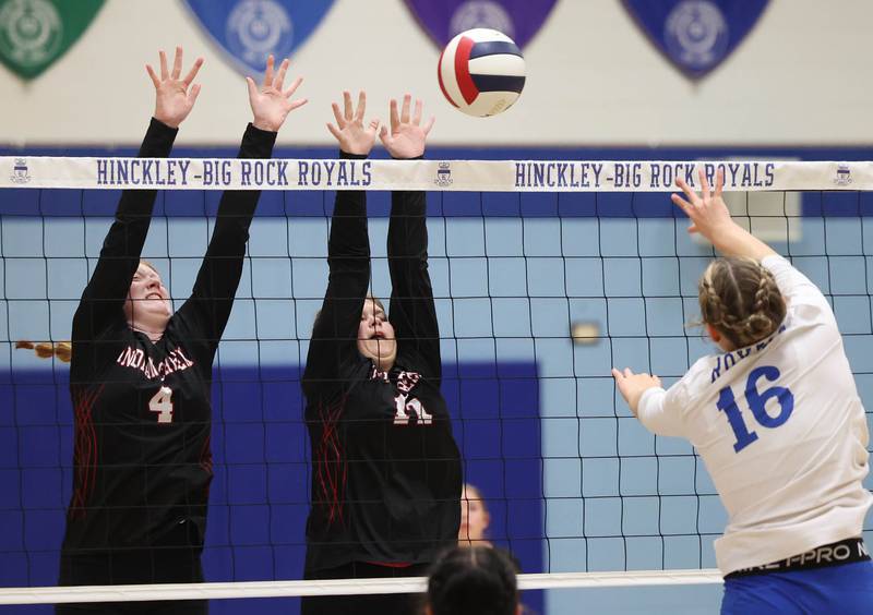 Indian Creek's Makayla Bateman (left) and Cheyenne Buh try to block the spike by Hinckley-Big Rock's Grace Barrett during their match Tuesday, Sept. 24, 2024, at Hinckley-Big Rock High School.