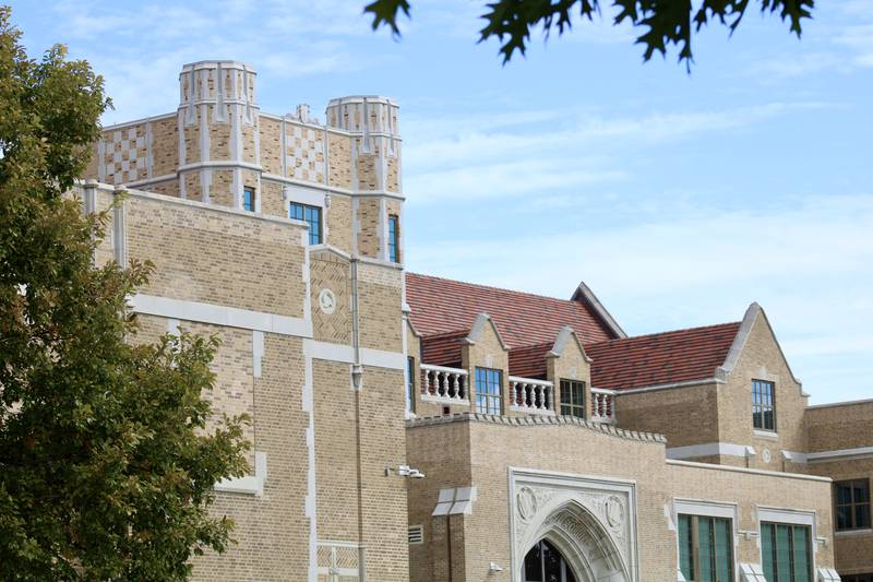 A view of the crenelated tower and profile of the Dixon High School rooftop from street level.