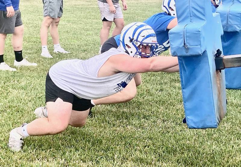 Princeton senior Rhett Pearson works on the blocking sleds during the first mini-camp in July. In the house where his father, Ryan, is the Tigers head coach, he said it's pretty much football 24-7.