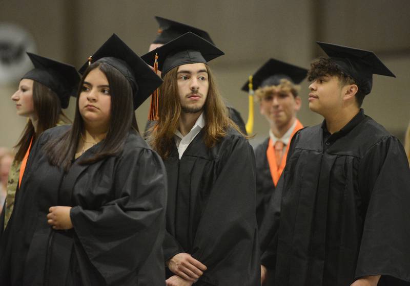 Joe Lewnard/jlewnard@dailyherald.com
Graduates enter during the processional of the Wheaton Warrenville South High School graduation, held at the College of Dupage in Glen Ellyn Saturday.