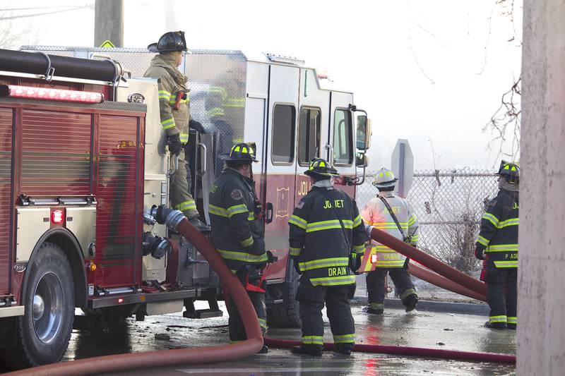 Joliet firefighters at the scene of a fire at an old commercial building on Thursday, Jan. 29, 2026, at the corner of South Eastern Avenue and Washington Street in Joliet.