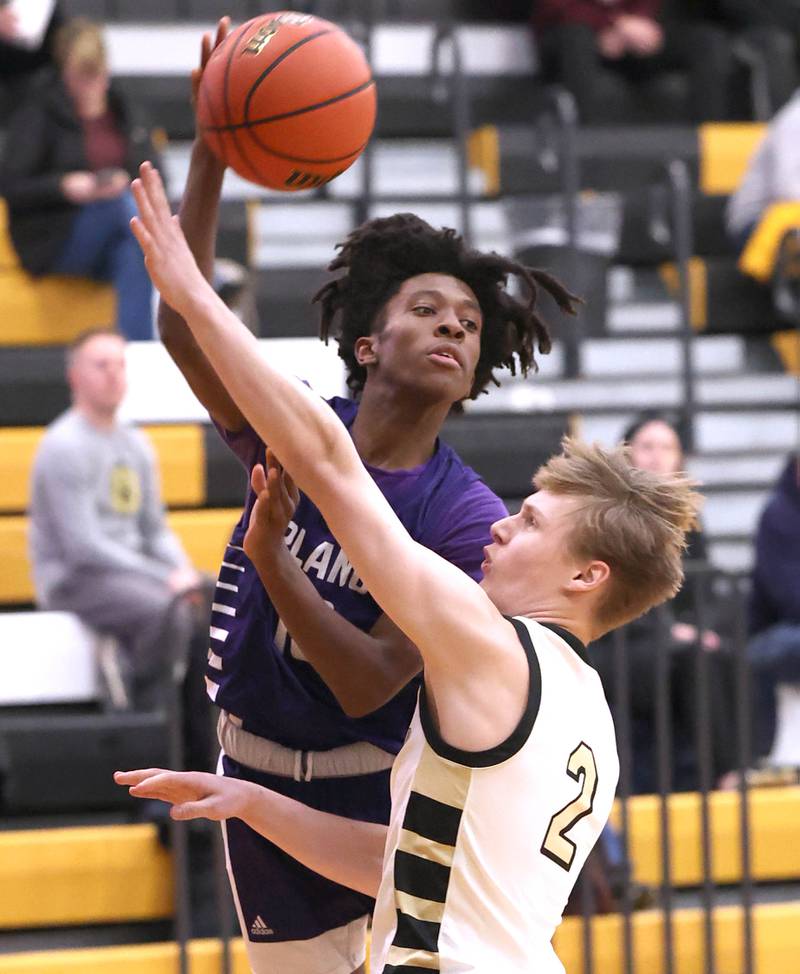 Plano’s Davione Stamps passes over Sycamore's Aidan Wyzard Tuesday, Jan. 3, 2023, during their game at Sycamore High School.