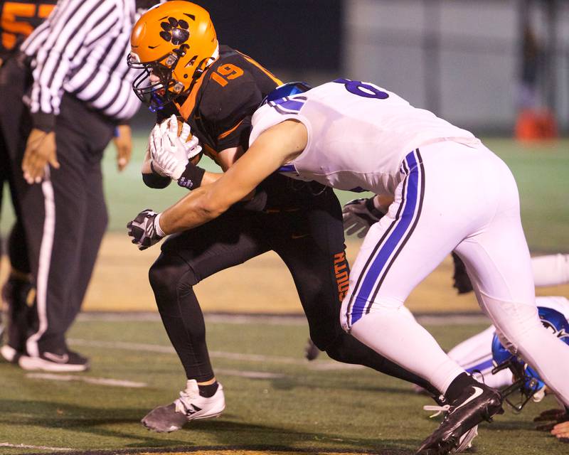 Wheaton Warrenville South's Brody Keith is tackled by St. Charles North's Matthew Plumb on Friday, Oct. 10, 2025 in Wheaton.