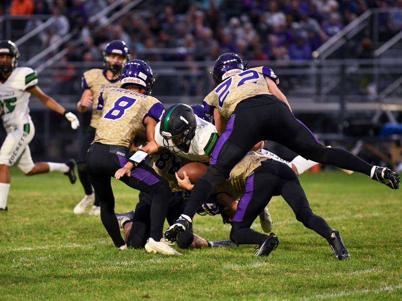Rock Falls quarterback Easton Canales fighting for yardage against Dixon's defense in Rock Falls on Friday, Sept. 8, 2023.