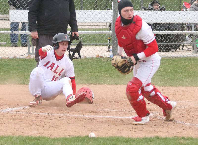 Hall's scores a run as the ball gets away from Ottawa catcher on Tuesday, April 1, 2025 at Ottawa High School.