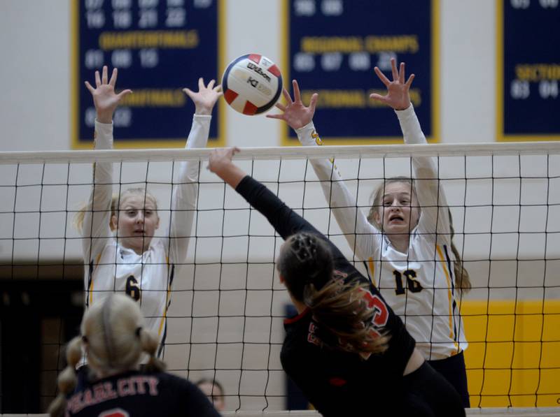 Polo's Syndei Rahn (6) and Bridget Call (16) try to block a spike by Pearl City's Anna Dampman during Thursday, Aug. 31, 2023 action at Polo High School.