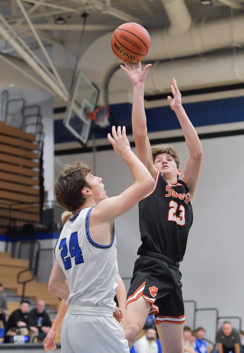 Wheaton Warrenville South Max O'Connell (23) takes a shot over St. Charles North's Colin Ross (24) during a game on Friday, December 2, 2022.