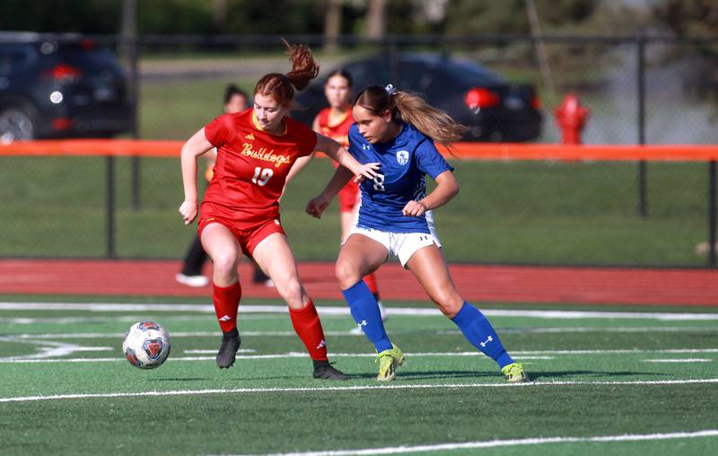 Batavia's Addison Wujciga and Geneva's Olivia Hagen go after the ball during a Tri-Cities Soccer Night game on Tuesday, April 29, 2025 at St. Charles East.