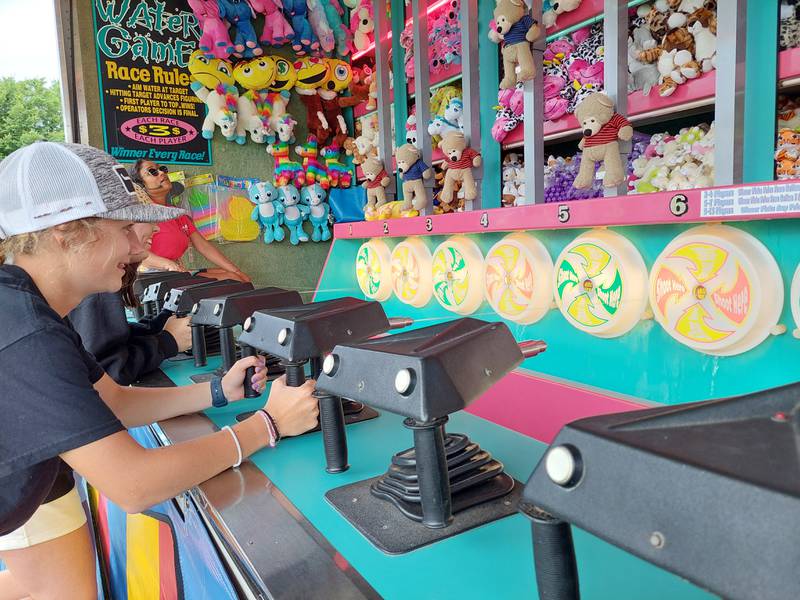 Lexi Wilson (front) and Allison Warren square off in the water gun race Thursday, June 27, 2024, at the Sheffield Summer Festival in West Park.