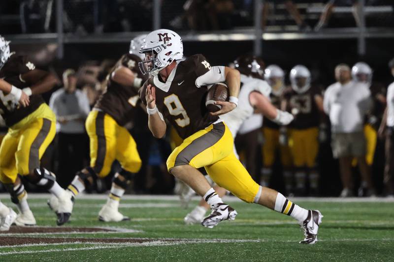 Mount Carmel’s Jack Elliott rushes to the outside against Joliet Catholic in an October game in Chicago.