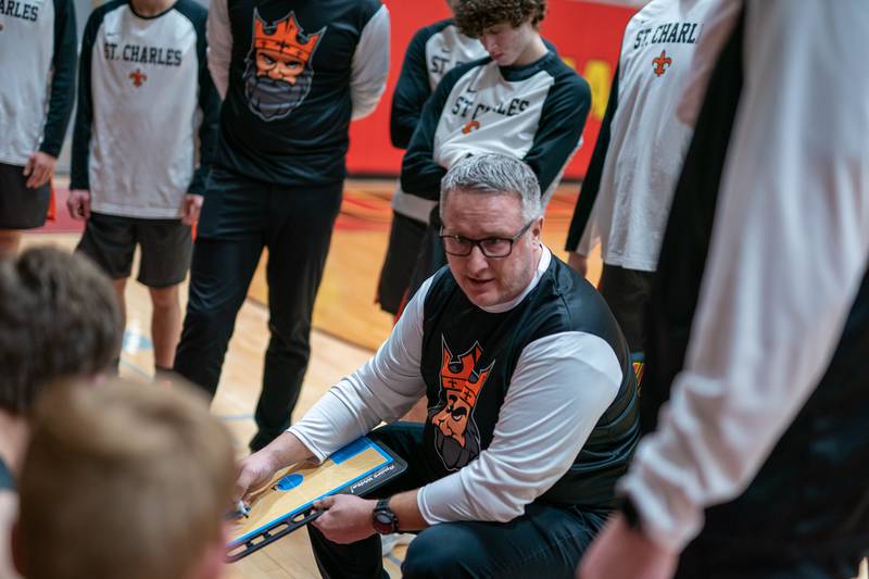 St. Charles East's head coach Pat Woods talks to his players during a basketball game against Batavia at Batavia High School on Friday, Feb 10, 2023.